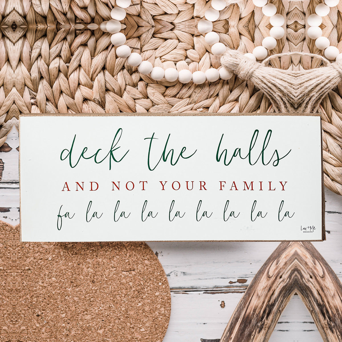 Handmade Deck The Halls Sign made of thick wood with a humorous Christmas quote in red and green, featuring a rustic textured area.