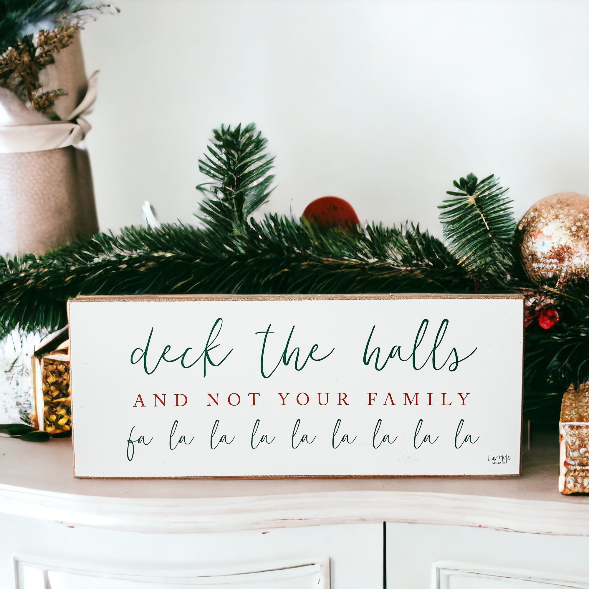 Handmade Deck The Halls Sign made of thick wood with a humorous Christmas quote in red and green, featuring a rustic textured area.