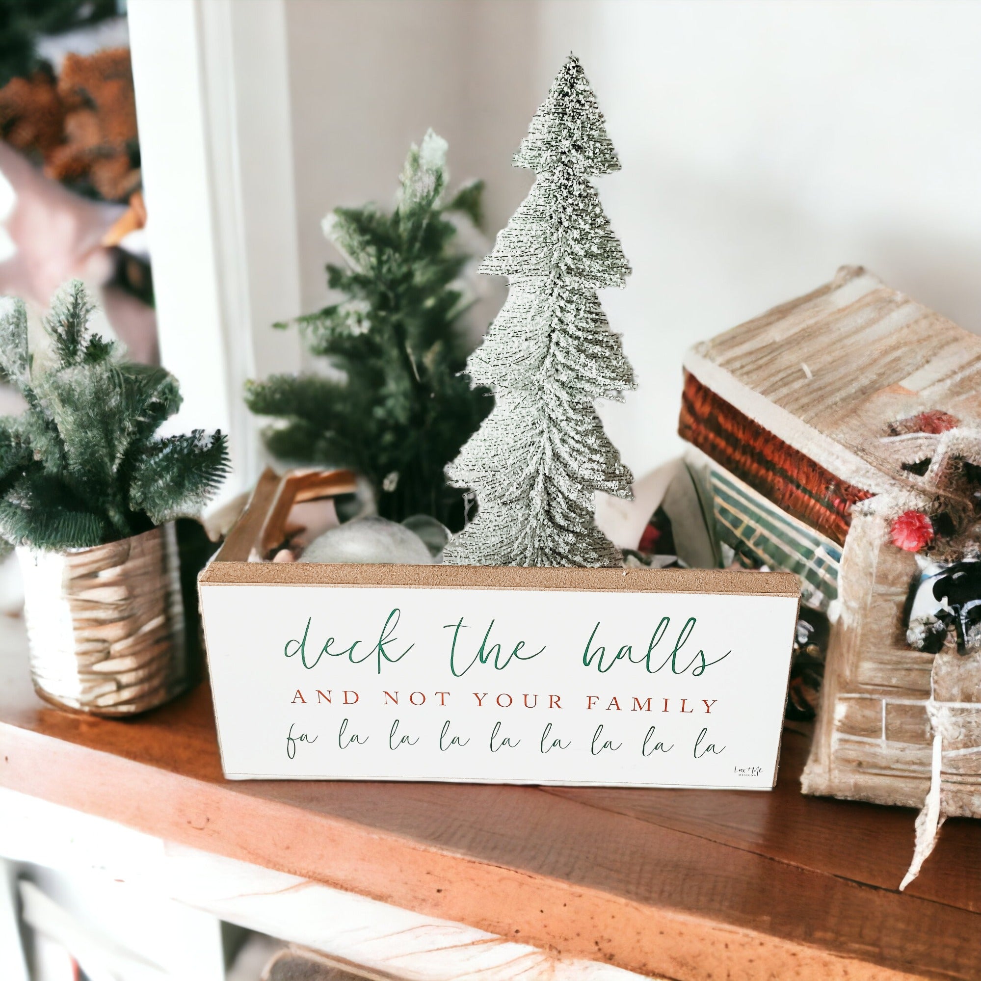 Handmade Deck The Halls Sign made of thick wood with a humorous Christmas quote in red and green, featuring a rustic textured area.