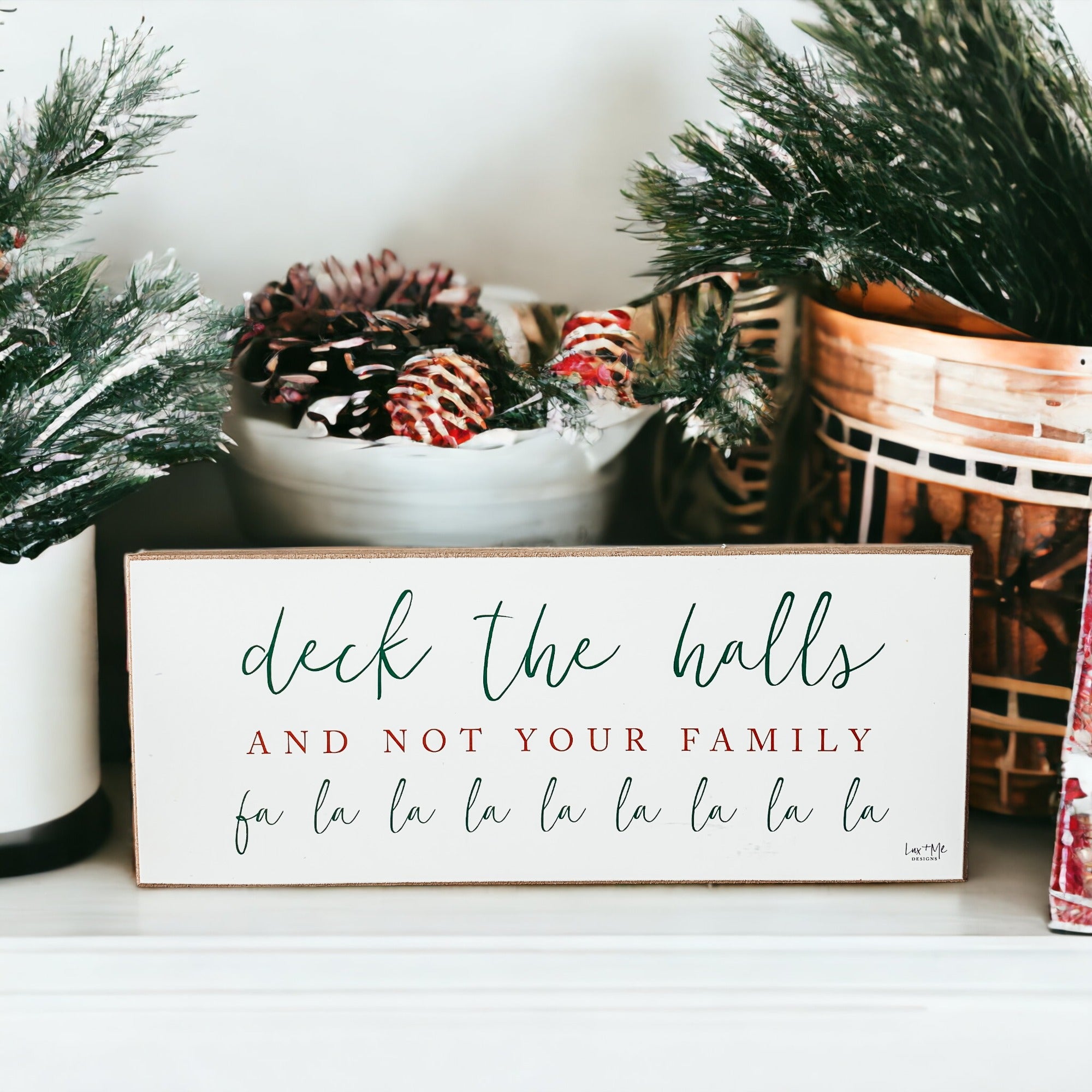 Handmade Deck The Halls Sign made of thick wood with a humorous Christmas quote in red and green, featuring a rustic textured area.