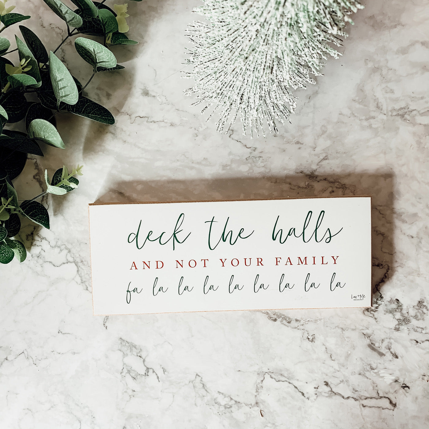 Handmade Deck The Halls Sign made of thick wood with a humorous Christmas quote in red and green, featuring a rustic textured area.