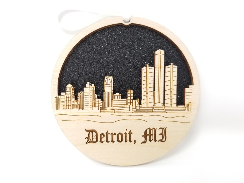 A beautifully crafted Detroit skyline ornament made from premium Baltic birch wood, showcasing intricate skyline details.