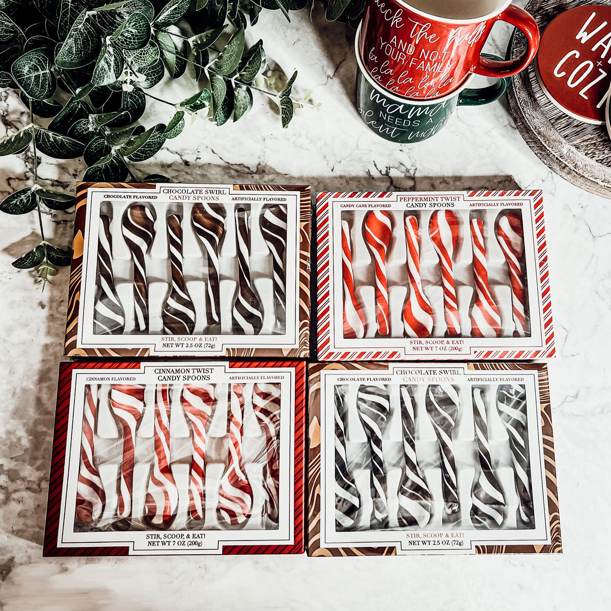 A colorful assortment of edible spoons in three flavors: Peppermint Twist, Cinnamon, and Hot Cocoa Twist, beautifully packaged in a gift box.