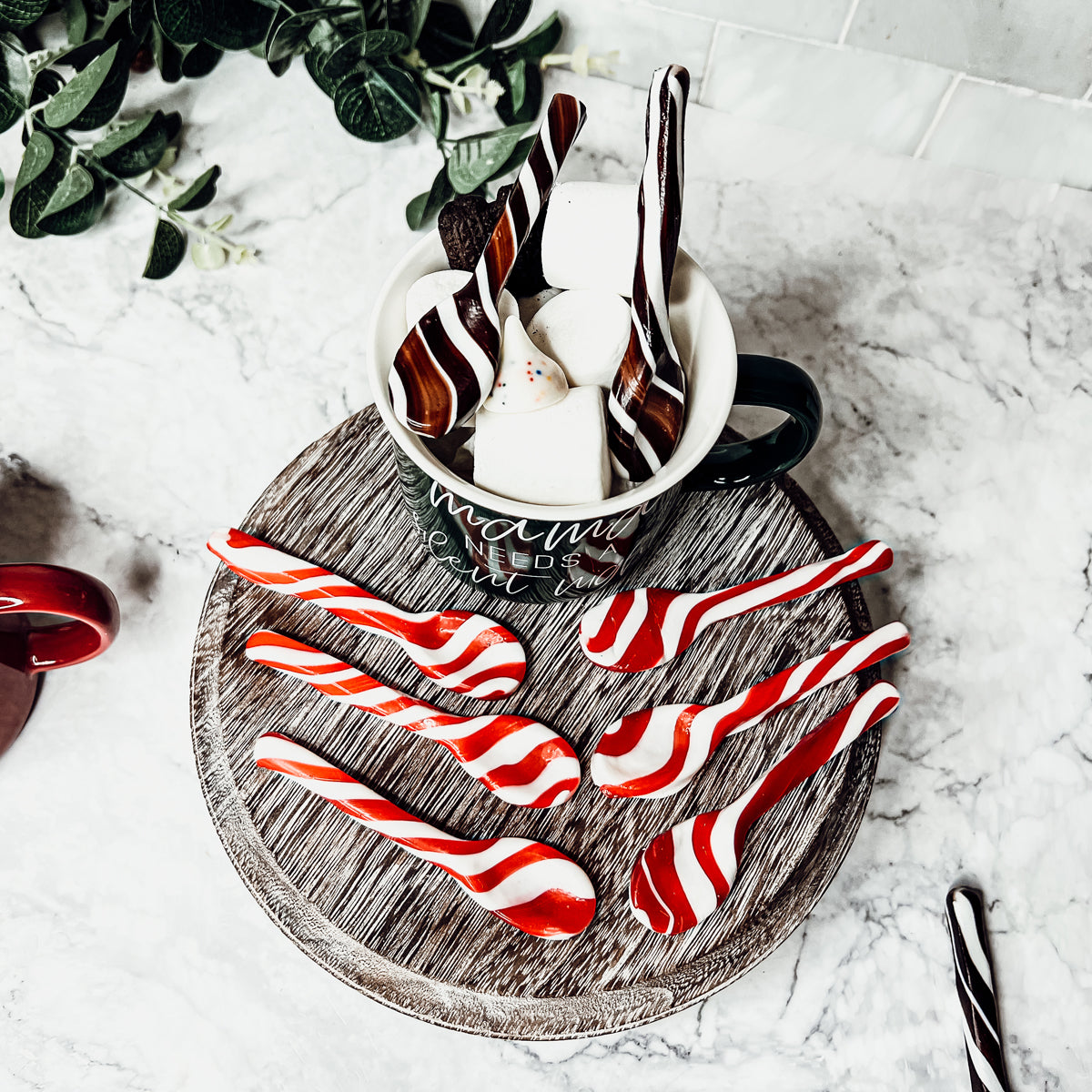 A colorful assortment of edible spoons in three flavors: Peppermint Twist, Cinnamon, and Hot Cocoa Twist, beautifully packaged in a gift box.