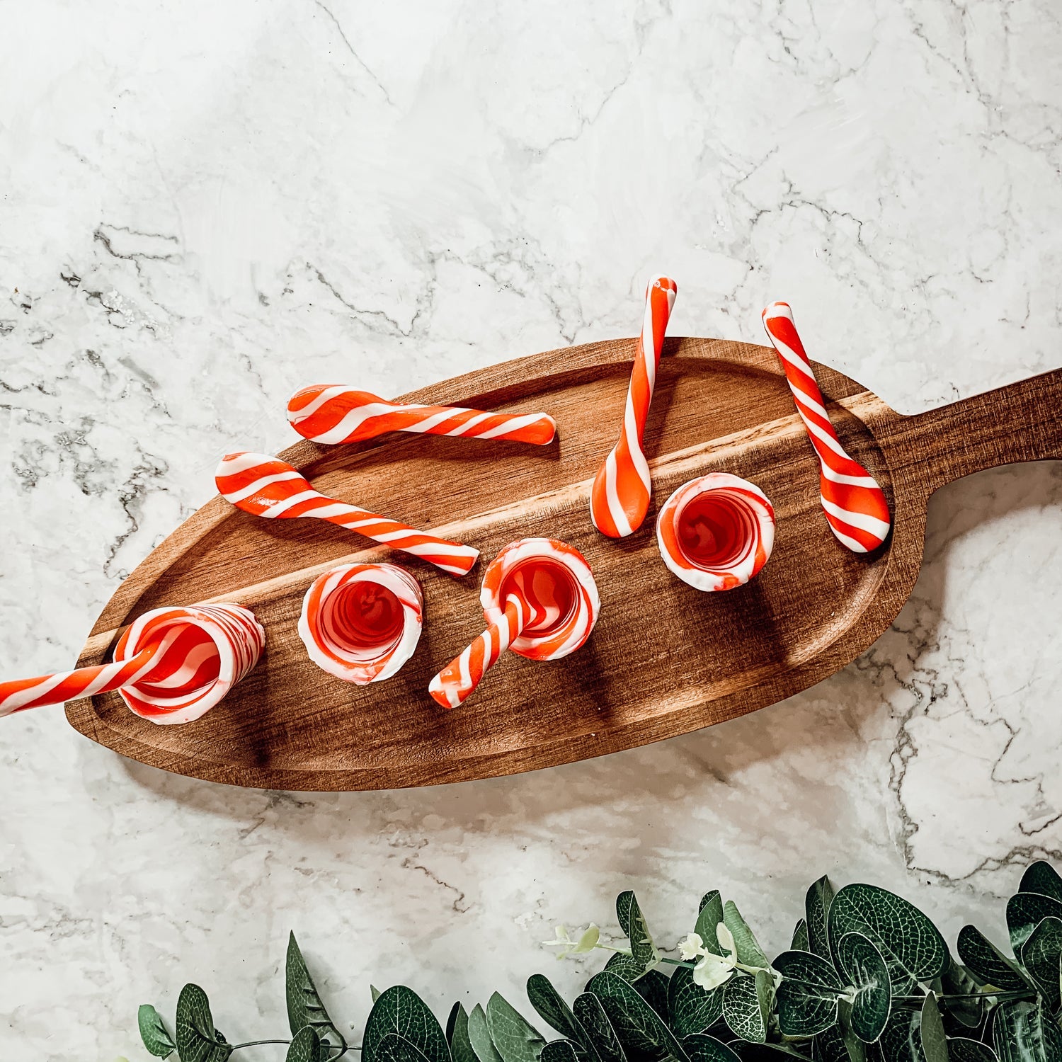 A colorful assortment of edible spoons in three flavors: Peppermint Twist, Cinnamon, and Hot Cocoa Twist, beautifully packaged in a gift box.