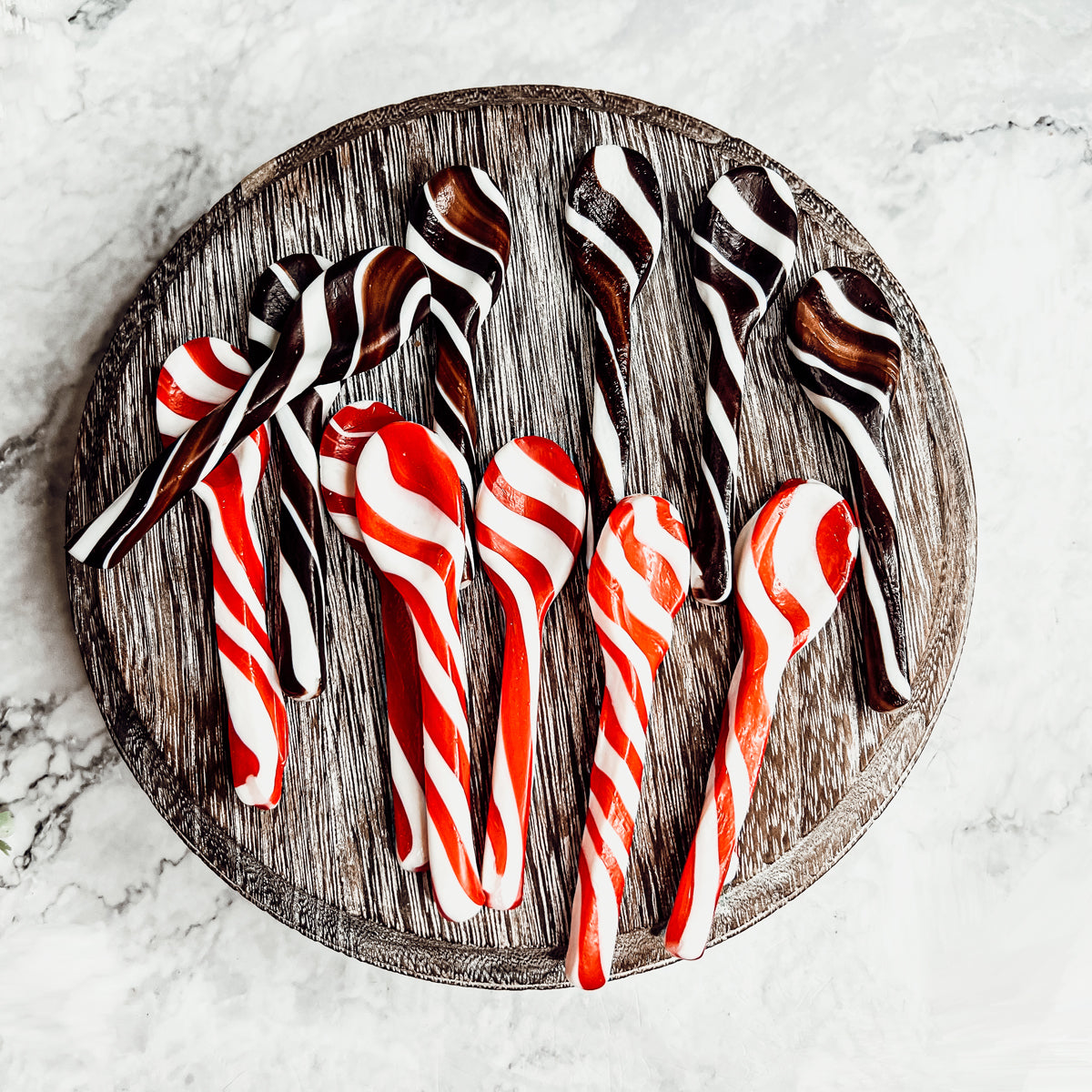 A colorful assortment of edible spoons in three flavors: Peppermint Twist, Cinnamon, and Hot Cocoa Twist, beautifully packaged in a gift box.