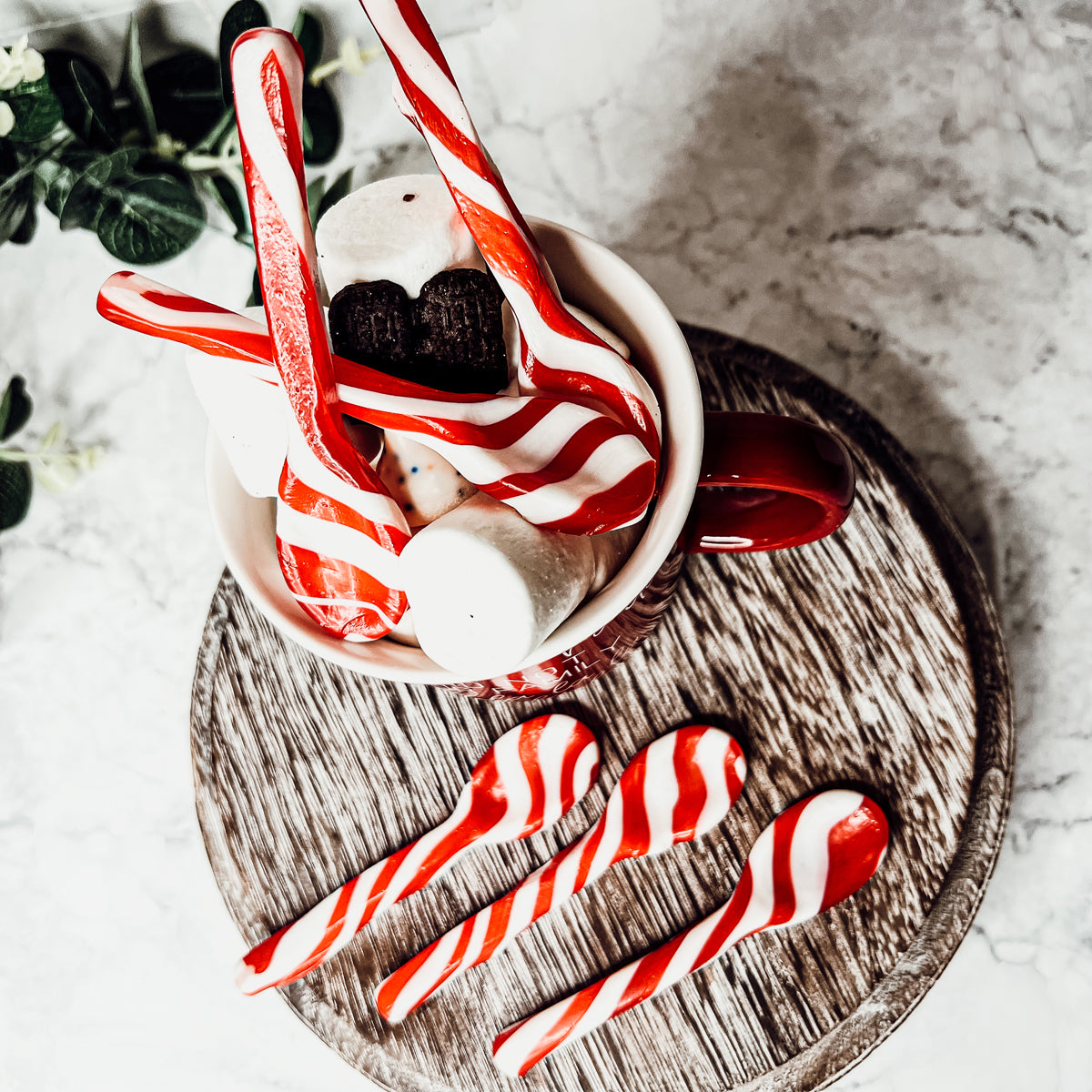 A colorful assortment of edible spoons in three flavors: Peppermint Twist, Cinnamon, and Hot Cocoa Twist, beautifully packaged in a gift box.