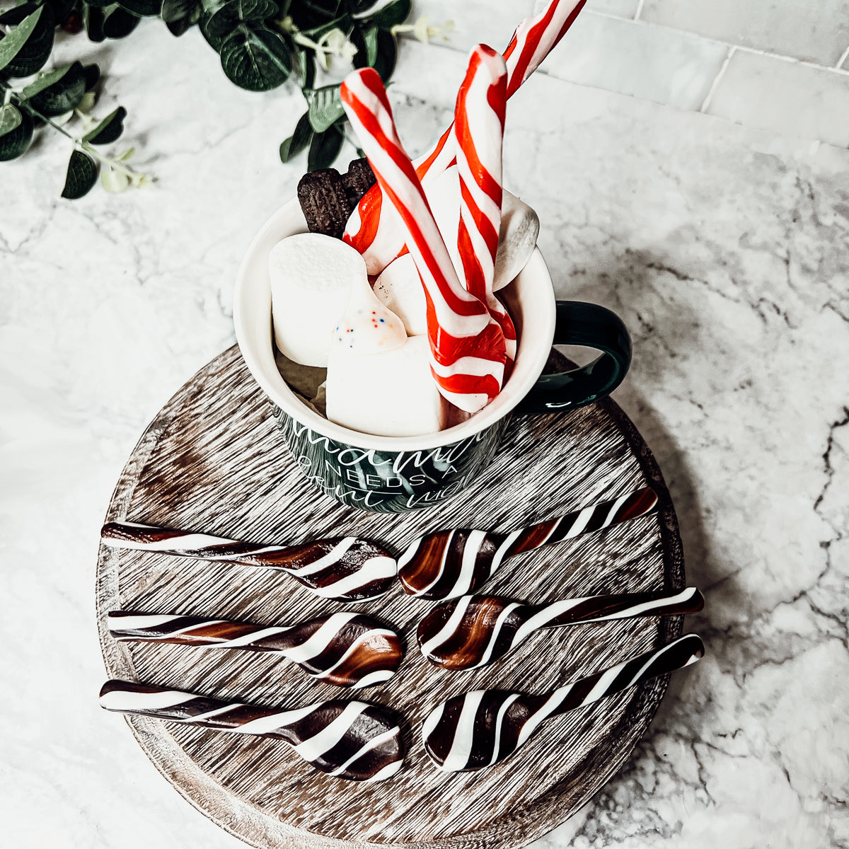 A colorful assortment of edible spoons in three flavors: Peppermint Twist, Cinnamon, and Hot Cocoa Twist, beautifully packaged in a gift box.