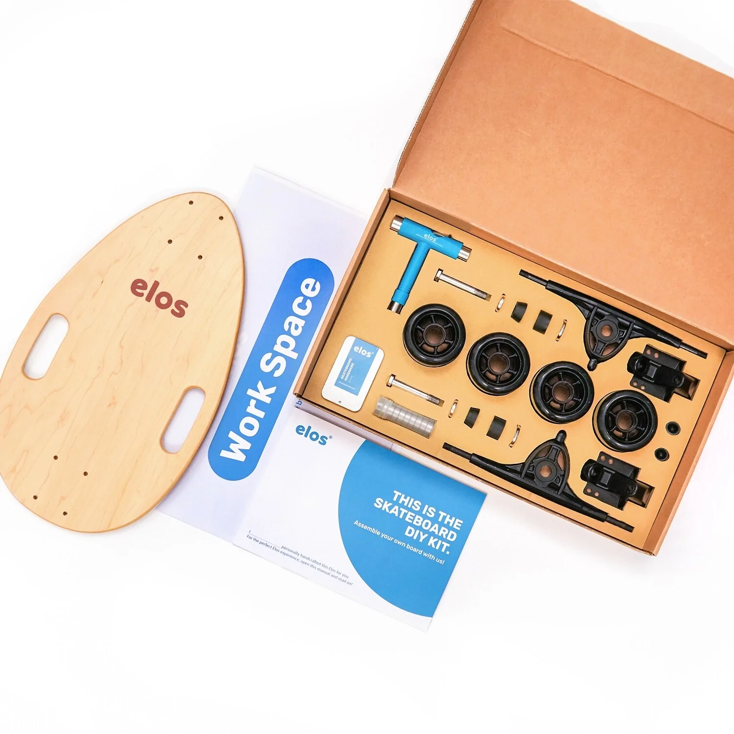 Elos Skateboards DIY Kit showcasing colorful skateboard parts and instruction booklet, perfect for family bonding and holiday fun.