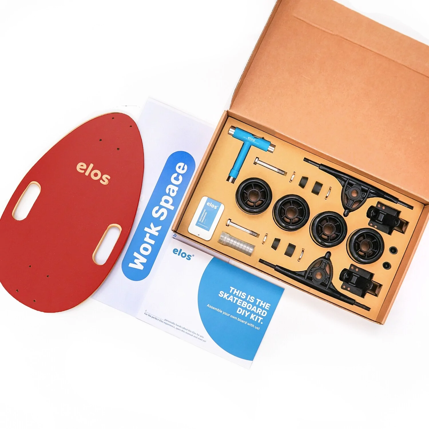 Elos Skateboards DIY Kit showcasing colorful skateboard parts and instruction booklet, perfect for family bonding and holiday fun.