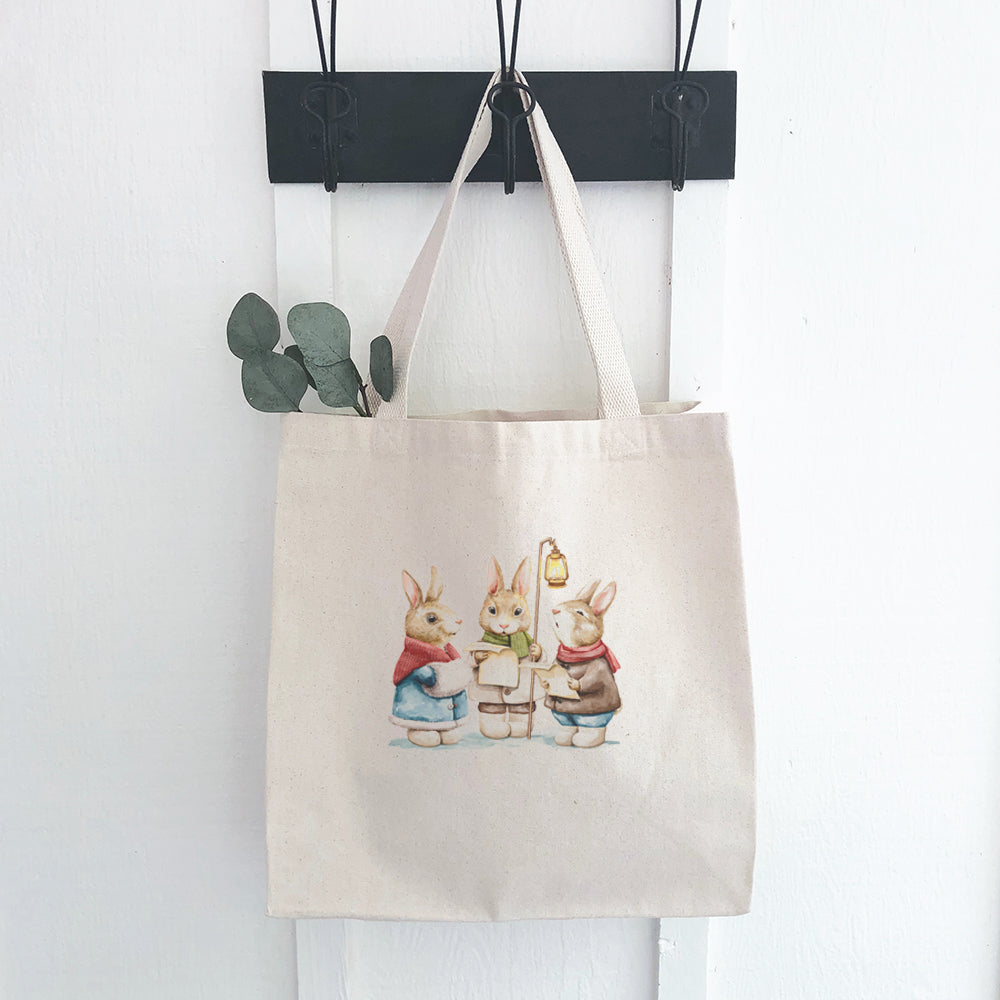 Fairytale Bunny Carolers canvas tote bag featuring vibrant colors and whimsical design, perfect for shopping or daily use.