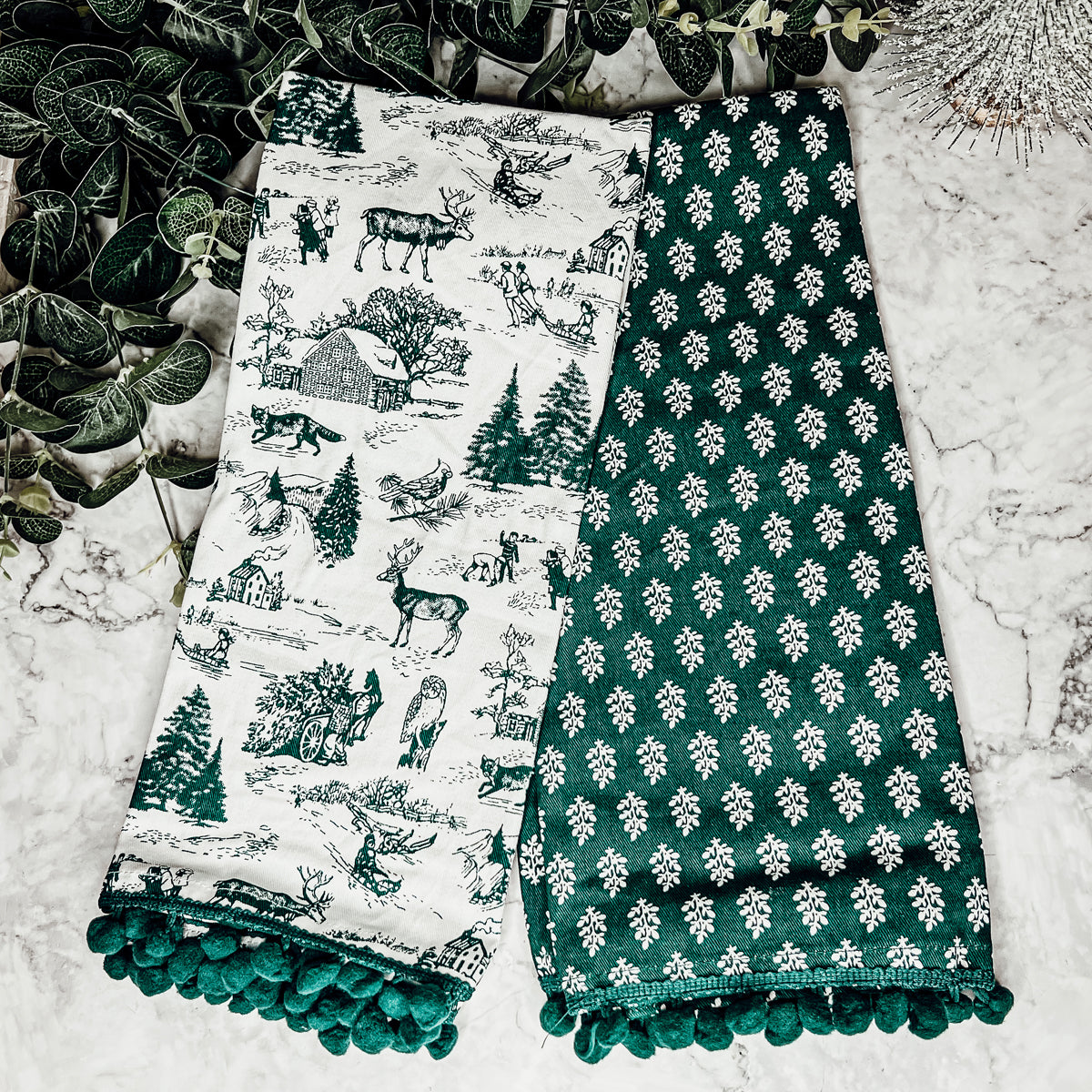 Set of two forest green dish towels with Christmas design, showcasing a classic forest pattern on durable cotton fabric.