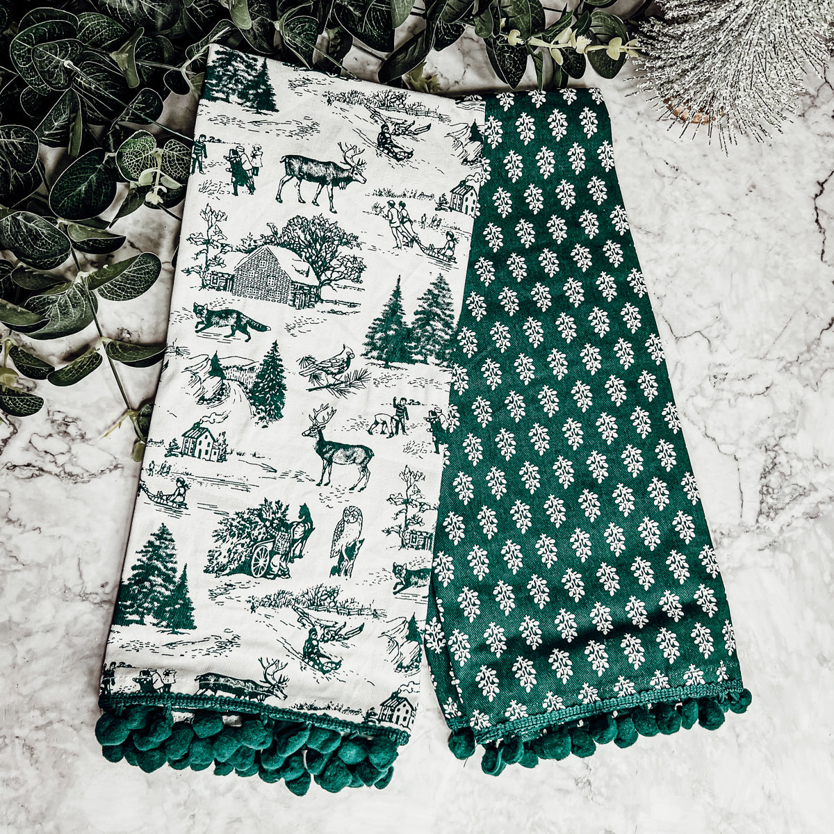 Set of two forest green dish towels with Christmas design, showcasing a classic forest pattern on durable cotton fabric.