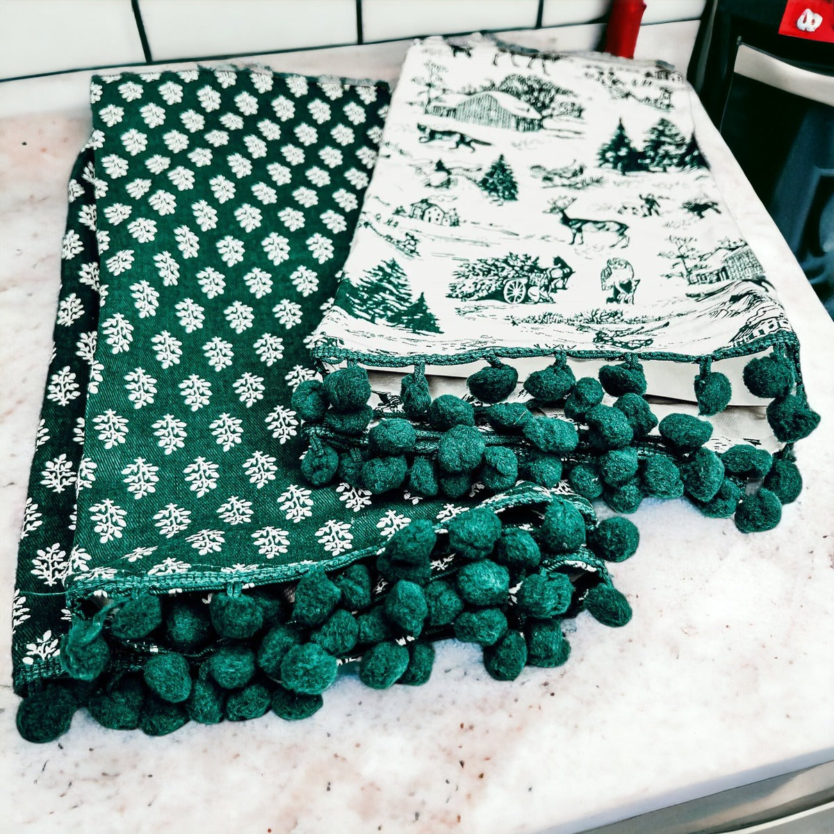 Set of two forest green dish towels with Christmas design, showcasing a classic forest pattern on durable cotton fabric.