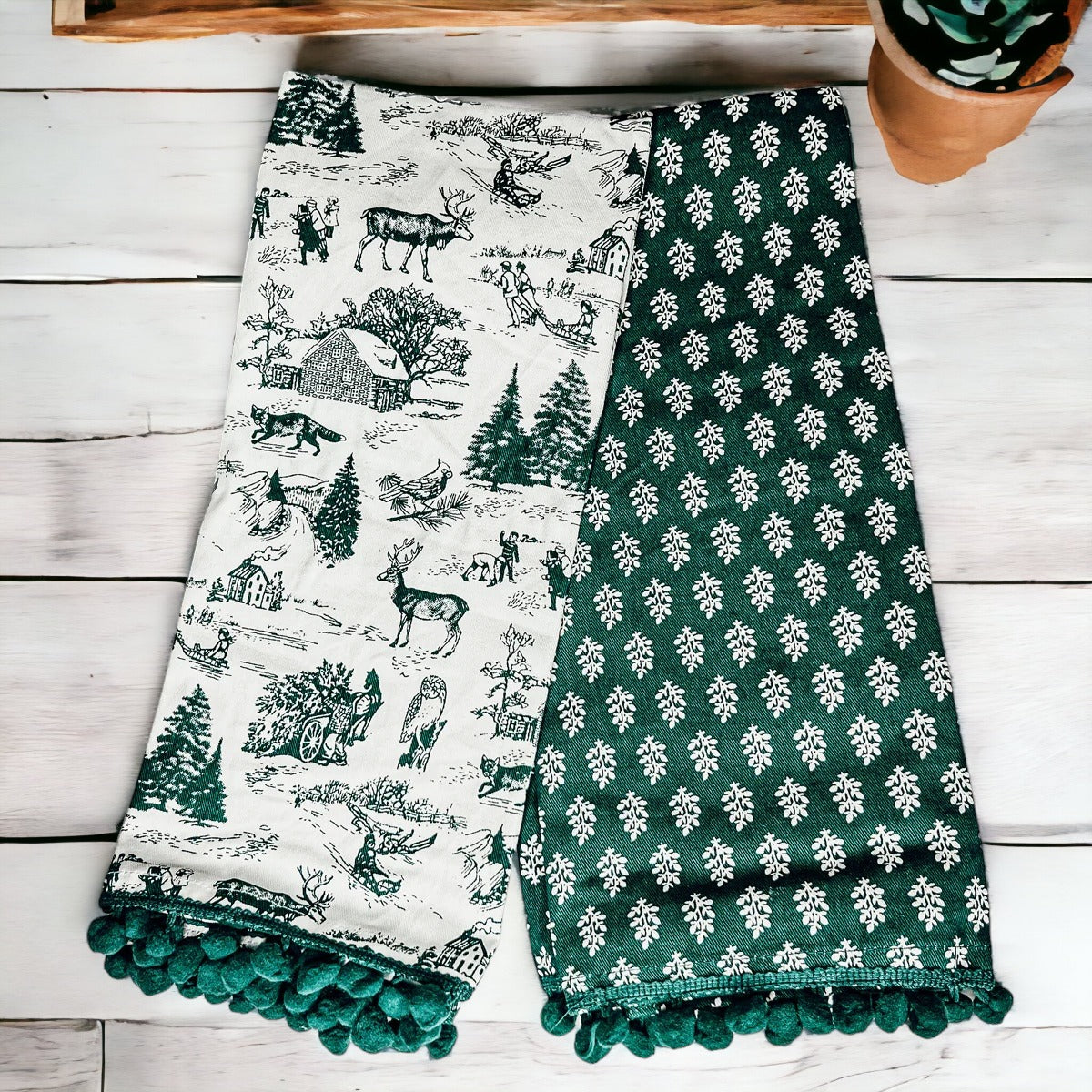 Set of two forest green dish towels with Christmas design, showcasing a classic forest pattern on durable cotton fabric.