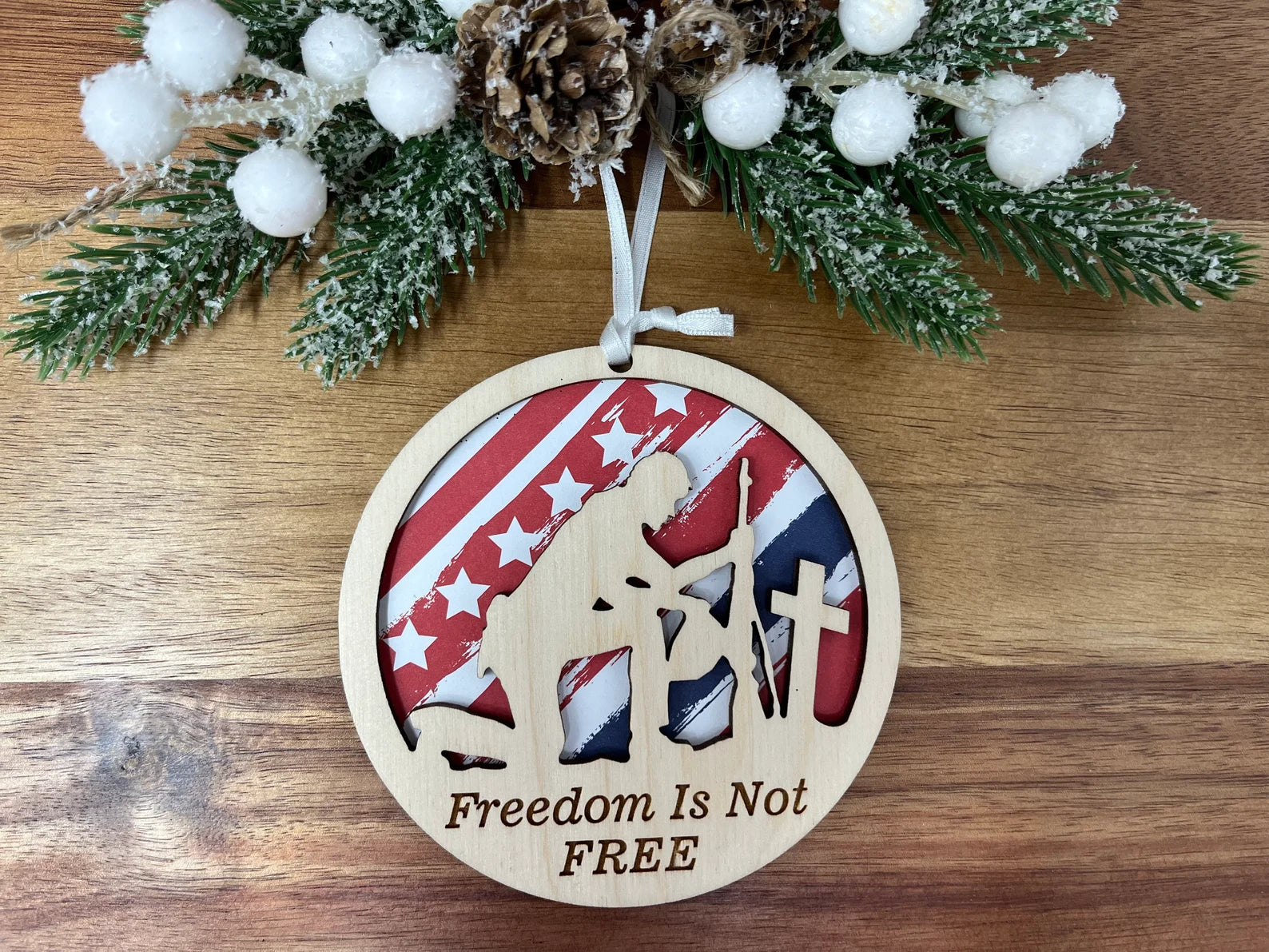 A beautifully crafted 'Freedom Is Not Free' ornament made from premium Baltic Birch wood, featuring intricate laser-cut designs.