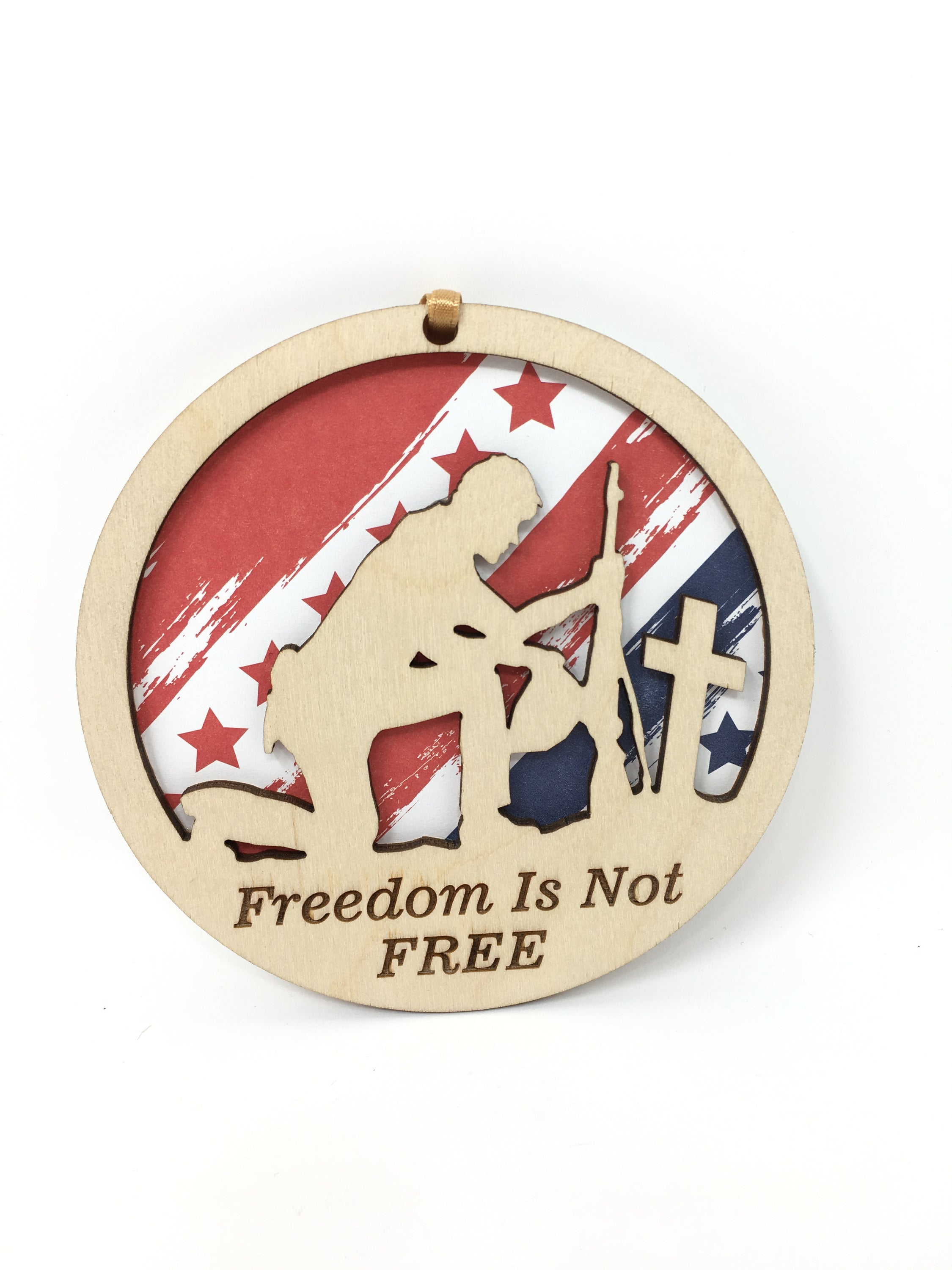 A beautifully crafted 'Freedom Is Not Free' ornament made from premium Baltic Birch wood, featuring intricate laser-cut designs.