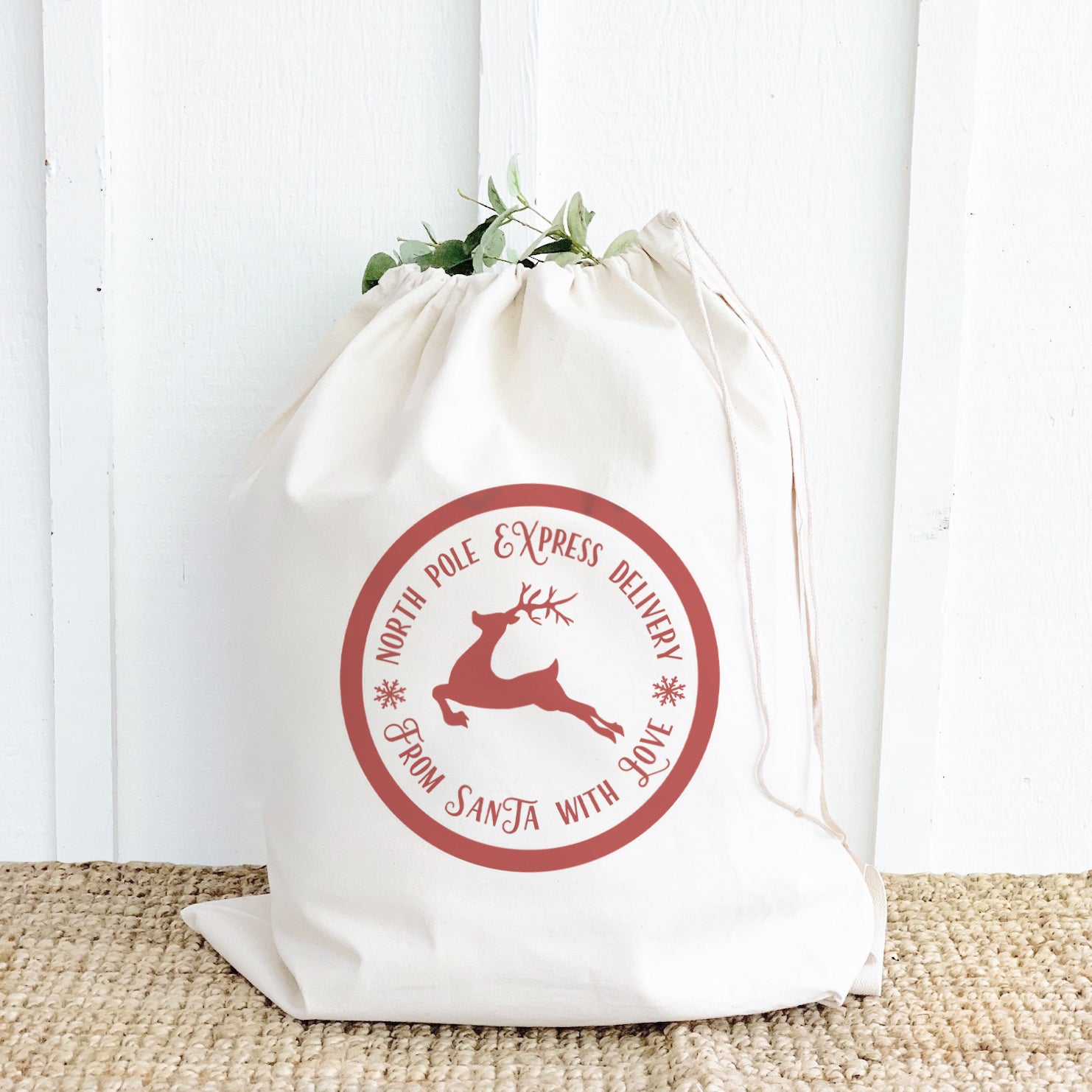 From Santa with Love Santa Sack made of heavy-duty canvas with a festive design and drawstring closure, perfect for carrying Christmas gifts.