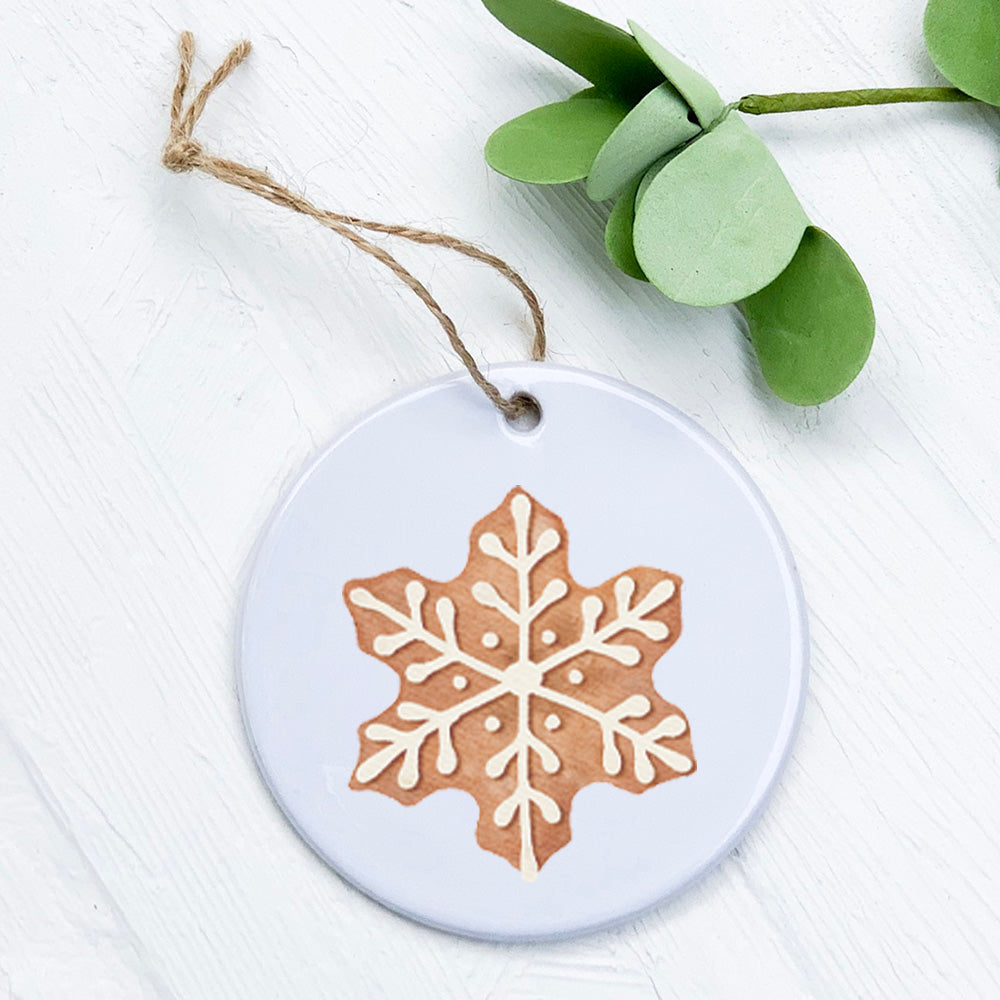 A beautifully crafted porcelain ornament featuring a gingerbread cookie design, perfect for holiday gifting and decoration.