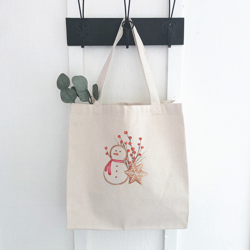 Gingerbread Snowman and Snowflake Canvas Tote Bag featuring a festive design, heavy-duty fabric, and reinforced straps.