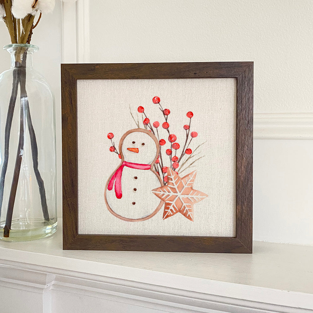 Gingerbread Snowman and Snowflake framed sign with a stylized wood frame, featuring eco-friendly printing on a linen-look background.