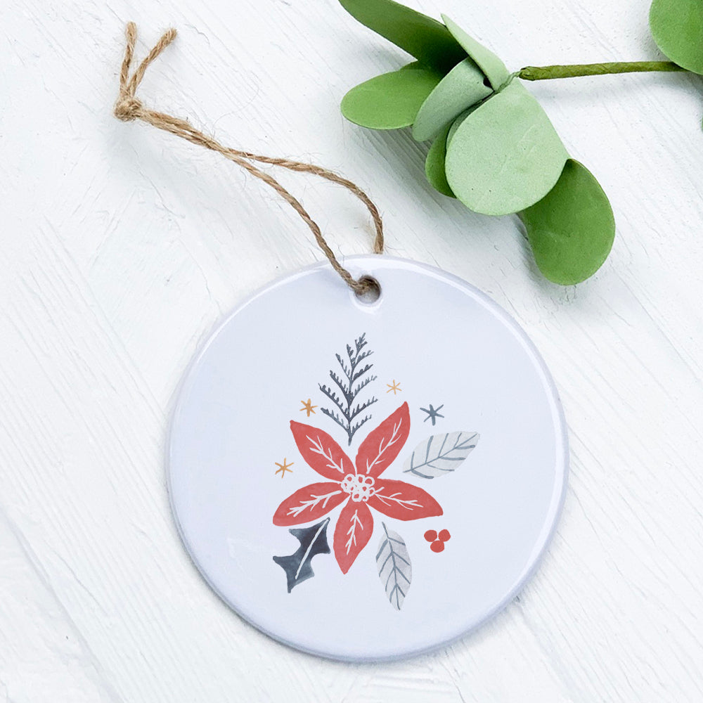 Hand Drawn Red Poinsettia ornament made of high-quality porcelain with a glossy finish, featuring a vibrant red floral design.