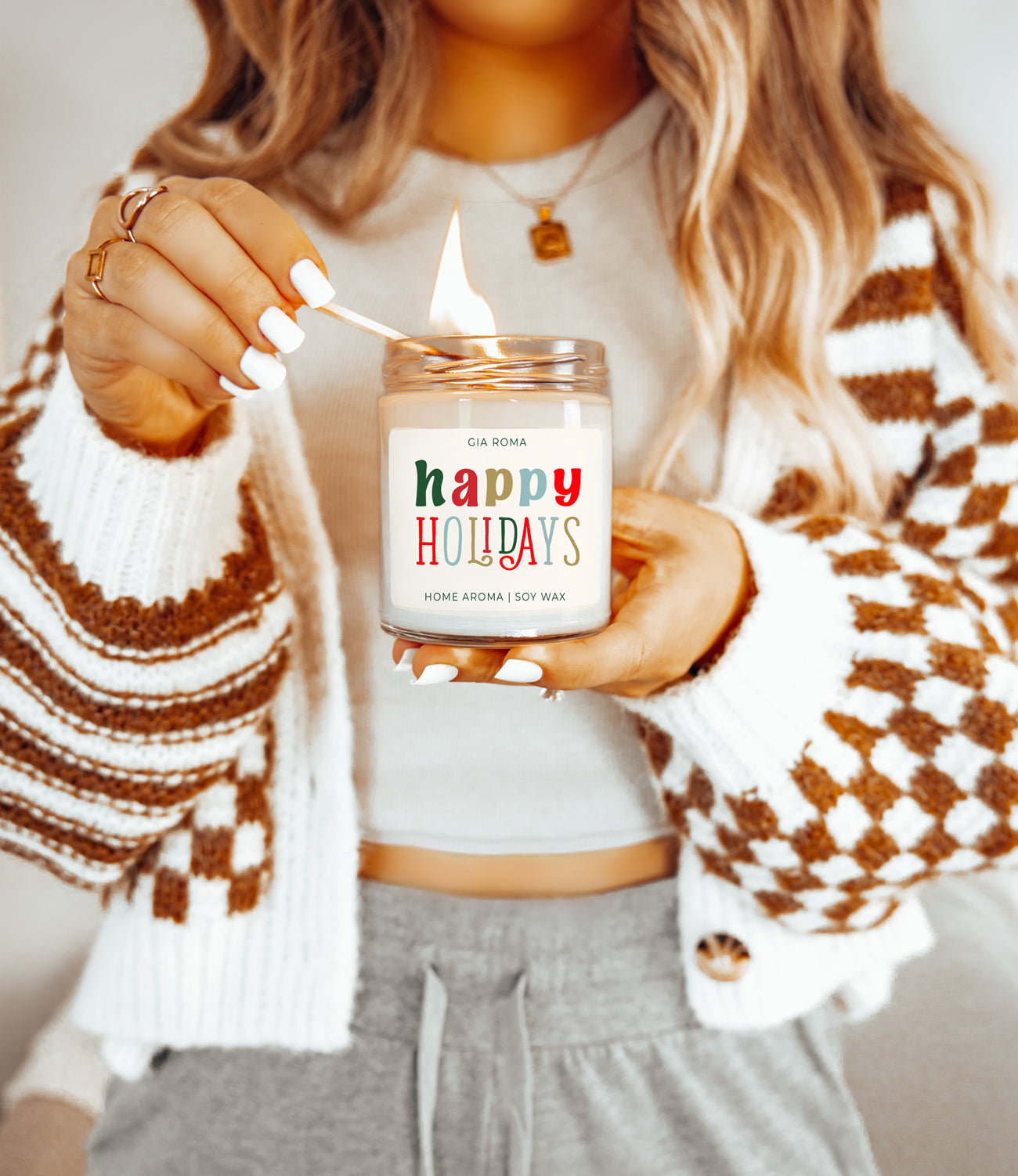 Happy Holiday Candle in a 9oz jar with festive scents of pine, orange, and woods, perfect for creating a cozy holiday atmosphere.