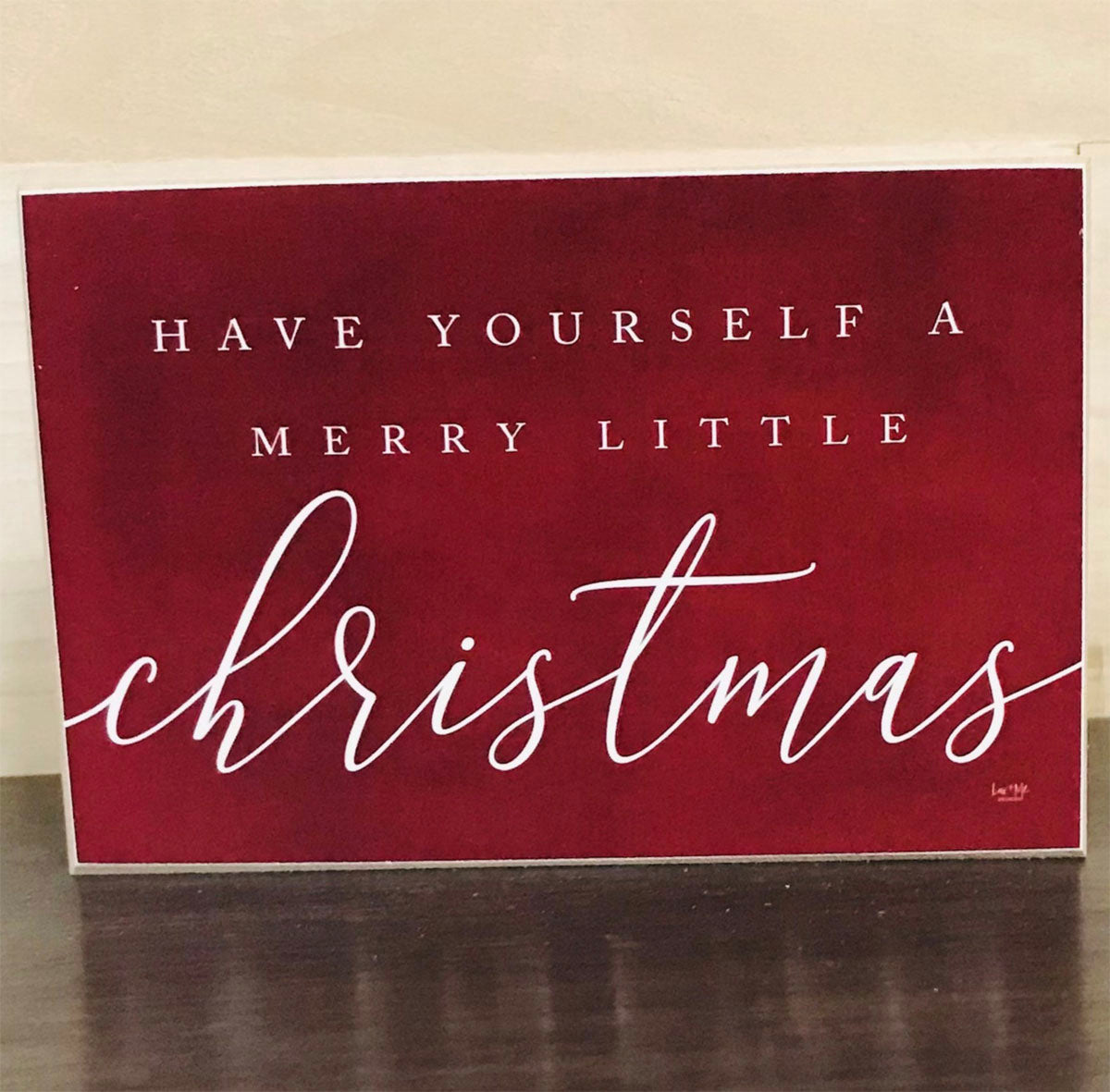 Wooden block sign with red background and white text reading 'Have Yourself a Merry Little Christmas', perfect for holiday decor.