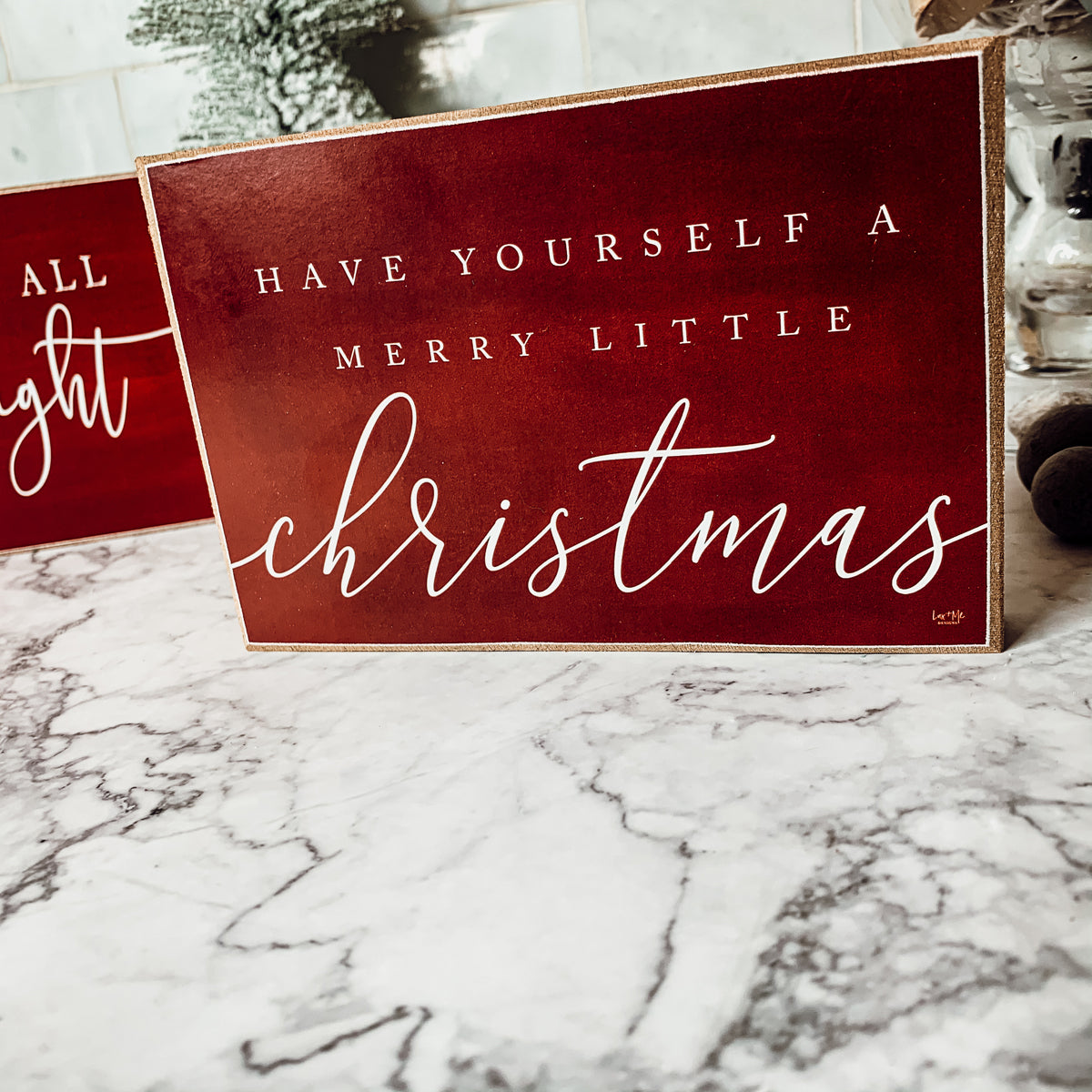 Wooden block sign with red background and white text reading 'Have Yourself a Merry Little Christmas', perfect for holiday decor.