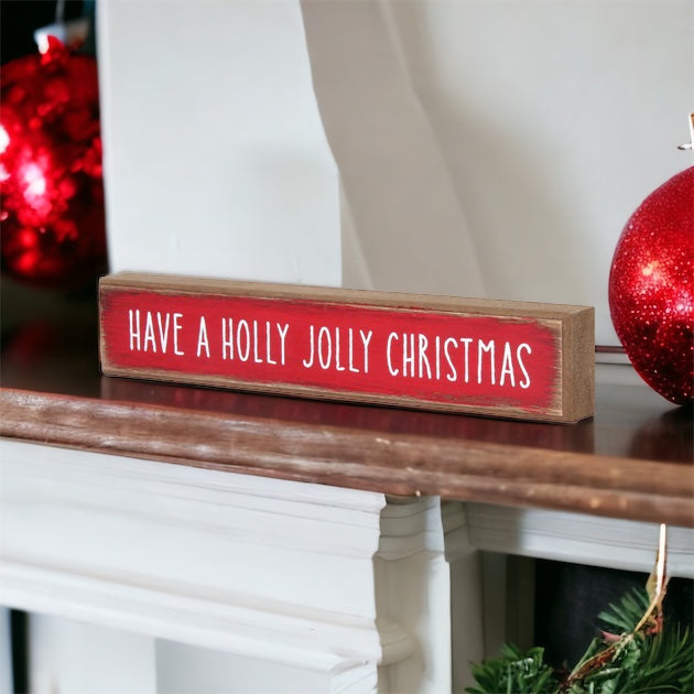 Holly Jolly Sitter Sign, a wooden block sign with festive lettering, perfect for holiday decor.