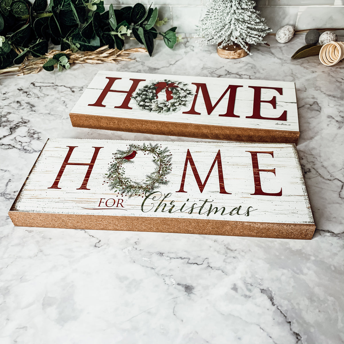 A beautifully crafted Home for Christmas Sign made of thick wood, featuring a festive wreath design on the letter 'O'.