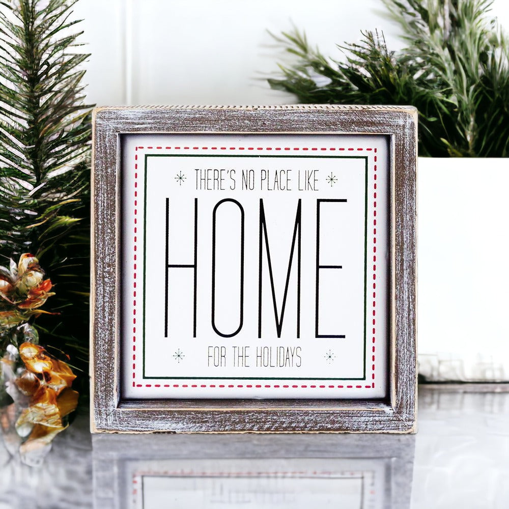 A stylish 7-inch framed sign that reads 'There's No Place Like Home for the Holidays' with a wooden frame and metal accents.