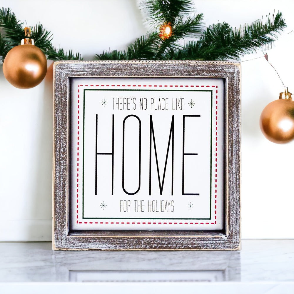 A stylish 7-inch framed sign that reads 'There's No Place Like Home for the Holidays' with a wooden frame and metal accents.