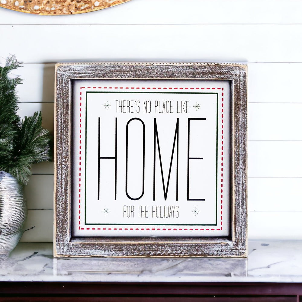 A stylish 7-inch framed sign that reads 'There's No Place Like Home for the Holidays' with a wooden frame and metal accents.