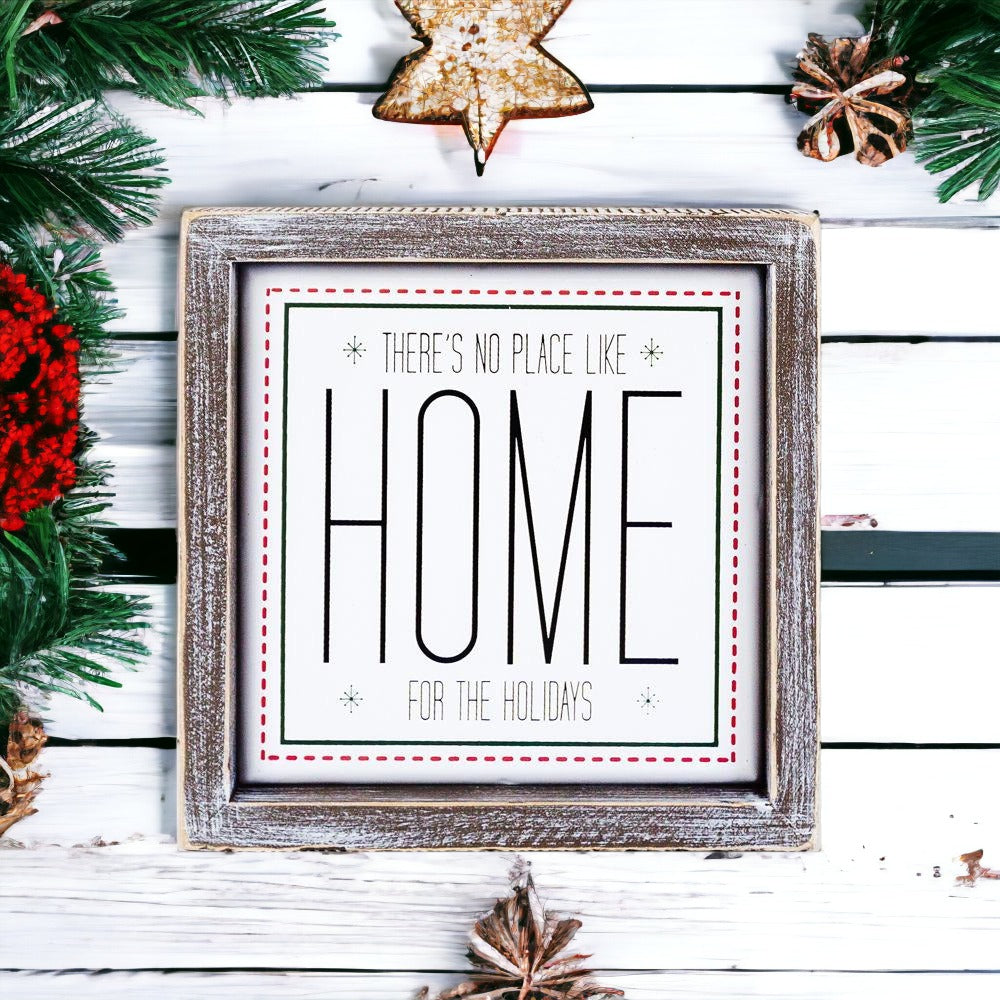 A stylish 7-inch framed sign that reads 'There's No Place Like Home for the Holidays' with a wooden frame and metal accents.