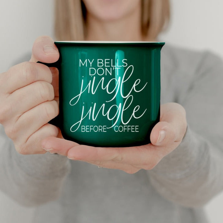 A festive Jingle Jingle Mug in red and green ceramic, featuring white lettering and a campfire style design, perfect for coffee lovers.