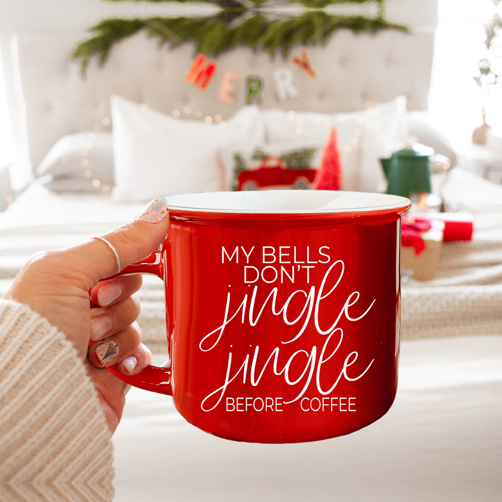 A festive Jingle Jingle Mug in red and green ceramic, featuring white lettering and a campfire style design, perfect for coffee lovers.