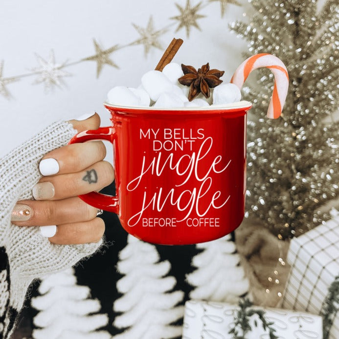 A festive Jingle Jingle Mug in red and green ceramic, featuring white lettering and a campfire style design, perfect for coffee lovers.