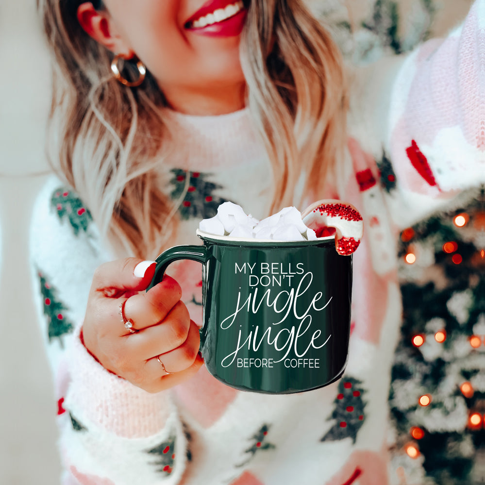 A festive Jingle Jingle Mug in red and green ceramic, featuring white lettering and a campfire style design, perfect for coffee lovers.