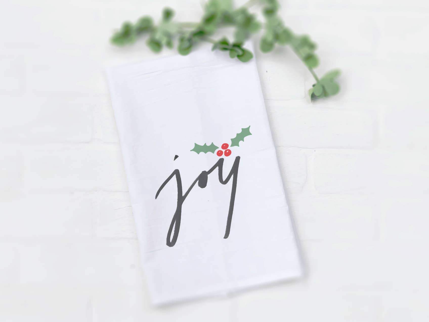 Joy Cotton Tea Towel featuring a vibrant design, made from 100% absorbent cotton, perfect for kitchen use.