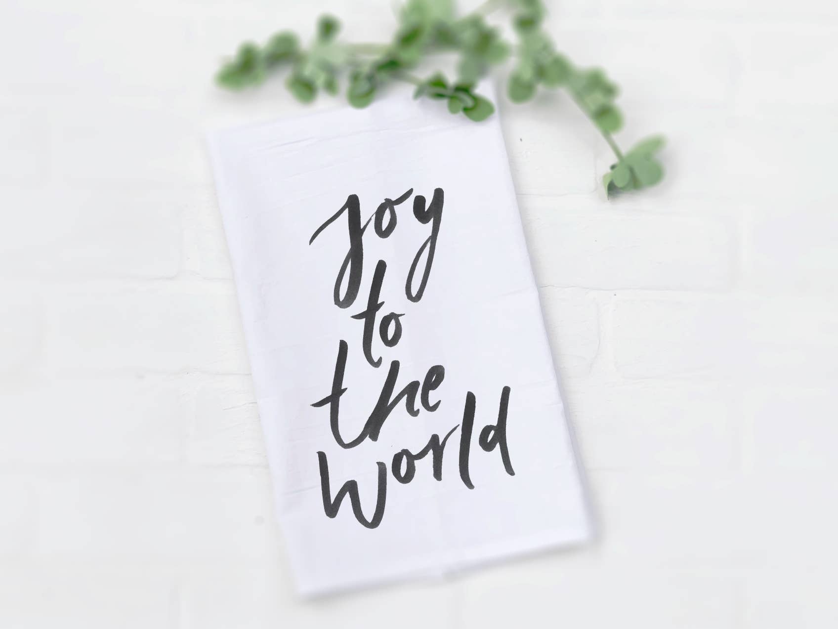 Joy to the World Cotton Tea Towel featuring vibrant designs, made from 100% absorbent cotton, measuring 27 inches square.