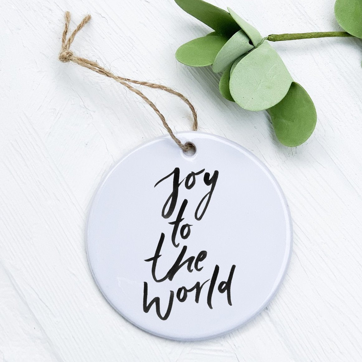 Joy to the World porcelain ornament featuring original design, 2.75 inches in diameter, with a smooth gloss finish.