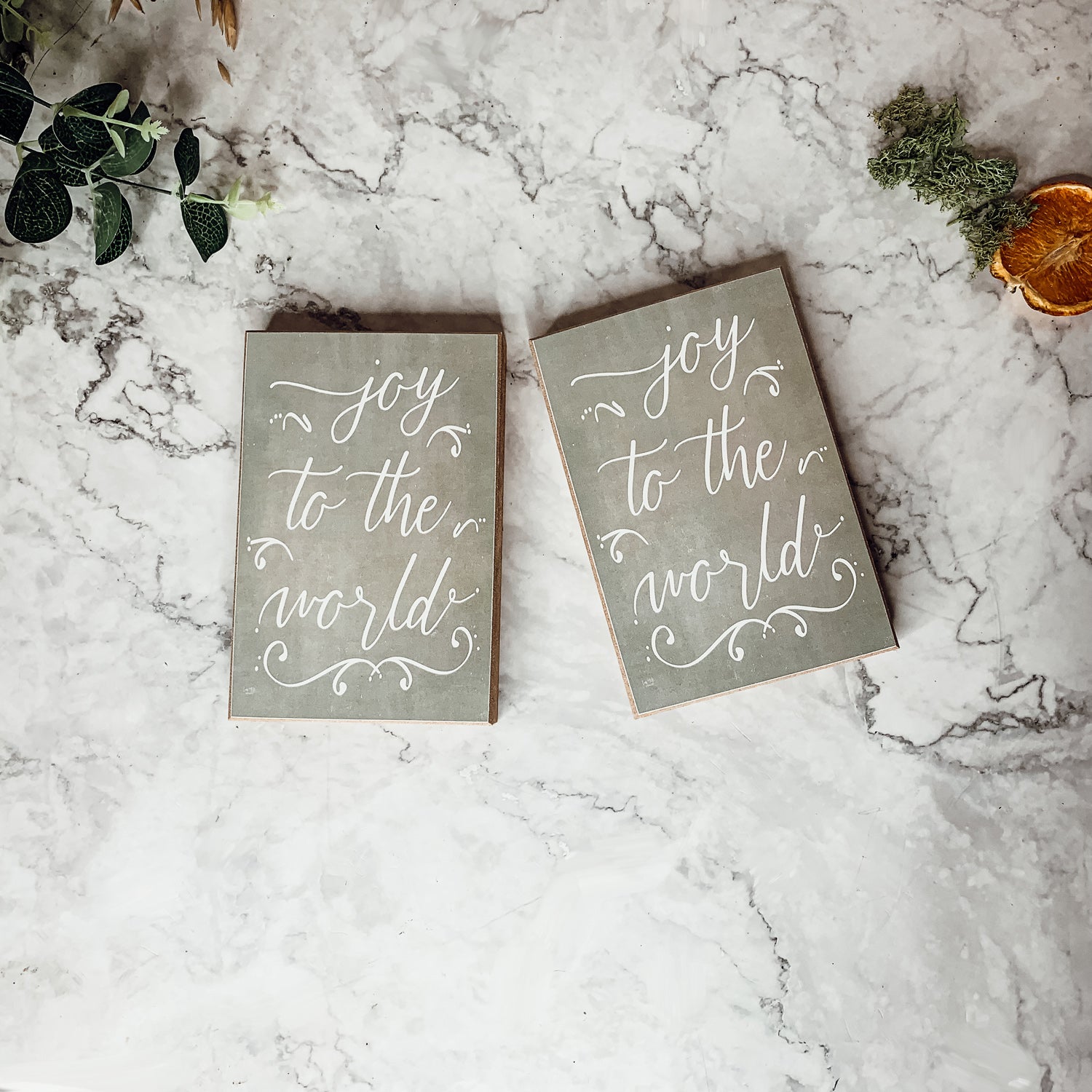 Joy To The World Sign with light gray textured background and festive text about Christmas trees and drinks.