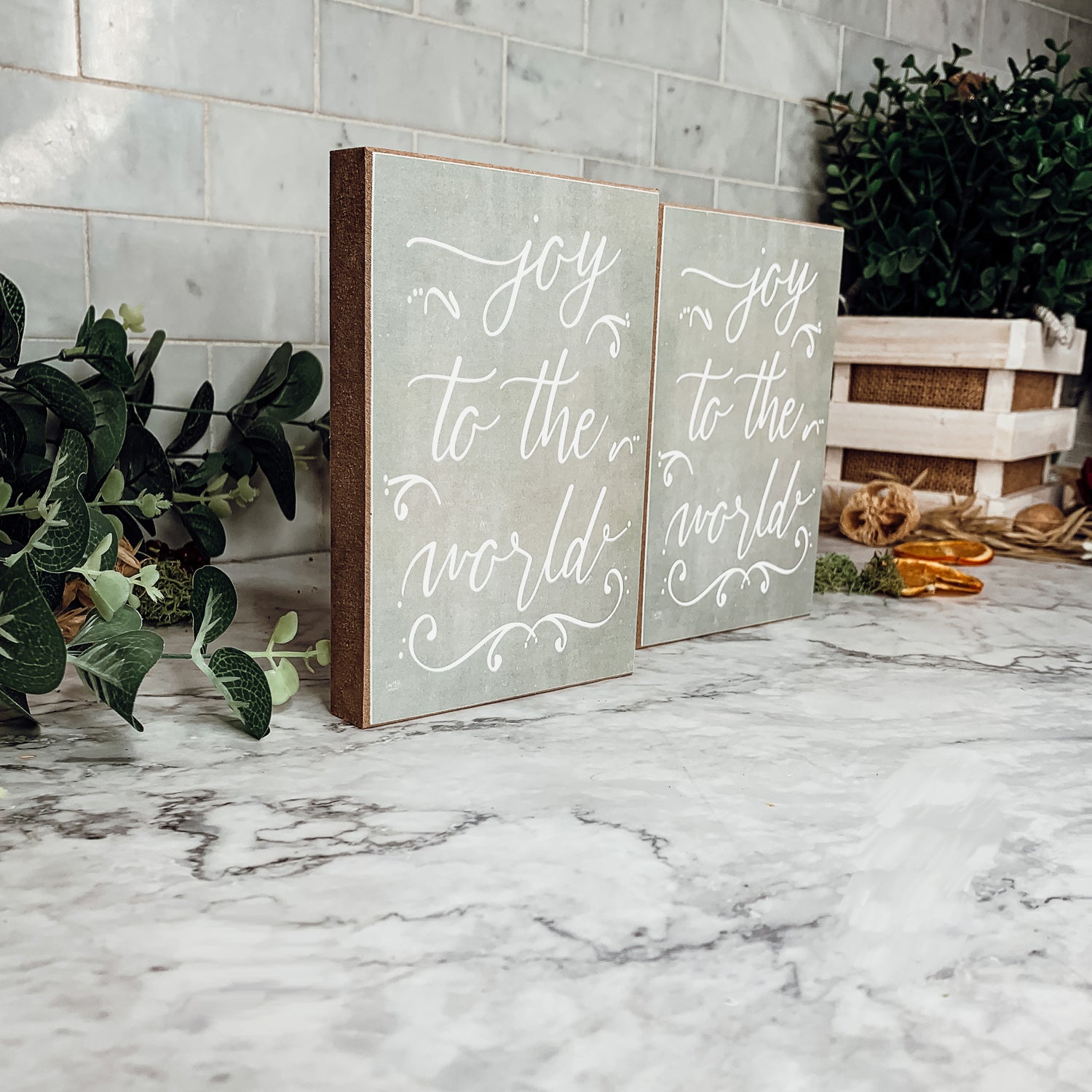 Joy To The World Sign with light gray textured background and festive text about Christmas trees and drinks.