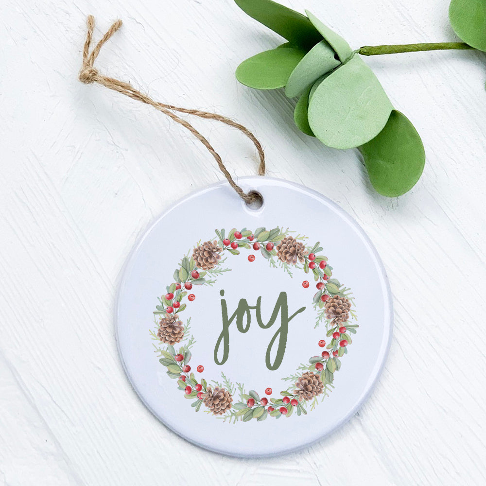 Joy Wreath Ornament made of high-quality porcelain with a vibrant design, measuring 2.75 inches in diameter.