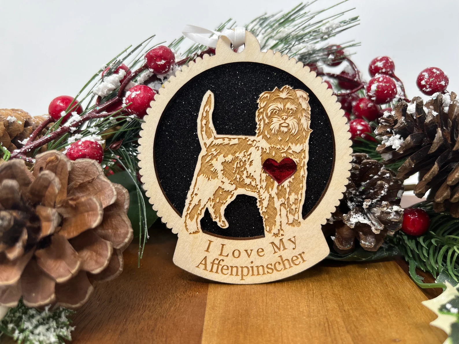 A beautifully crafted wooden ornament featuring a laser-cut silhouette of an Affenpinscher, perfect for holiday decor.