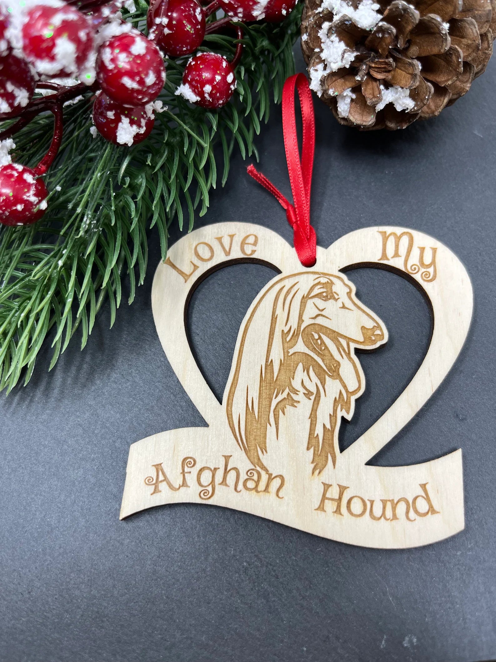 Laser engraved wooden ornament featuring an Afghan Hound, perfect for Christmas decoration.