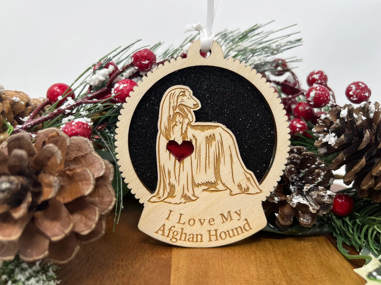 A beautifully crafted laser-cut wooden ornament featuring an Afghan Hound silhouette, perfect for holiday decor.