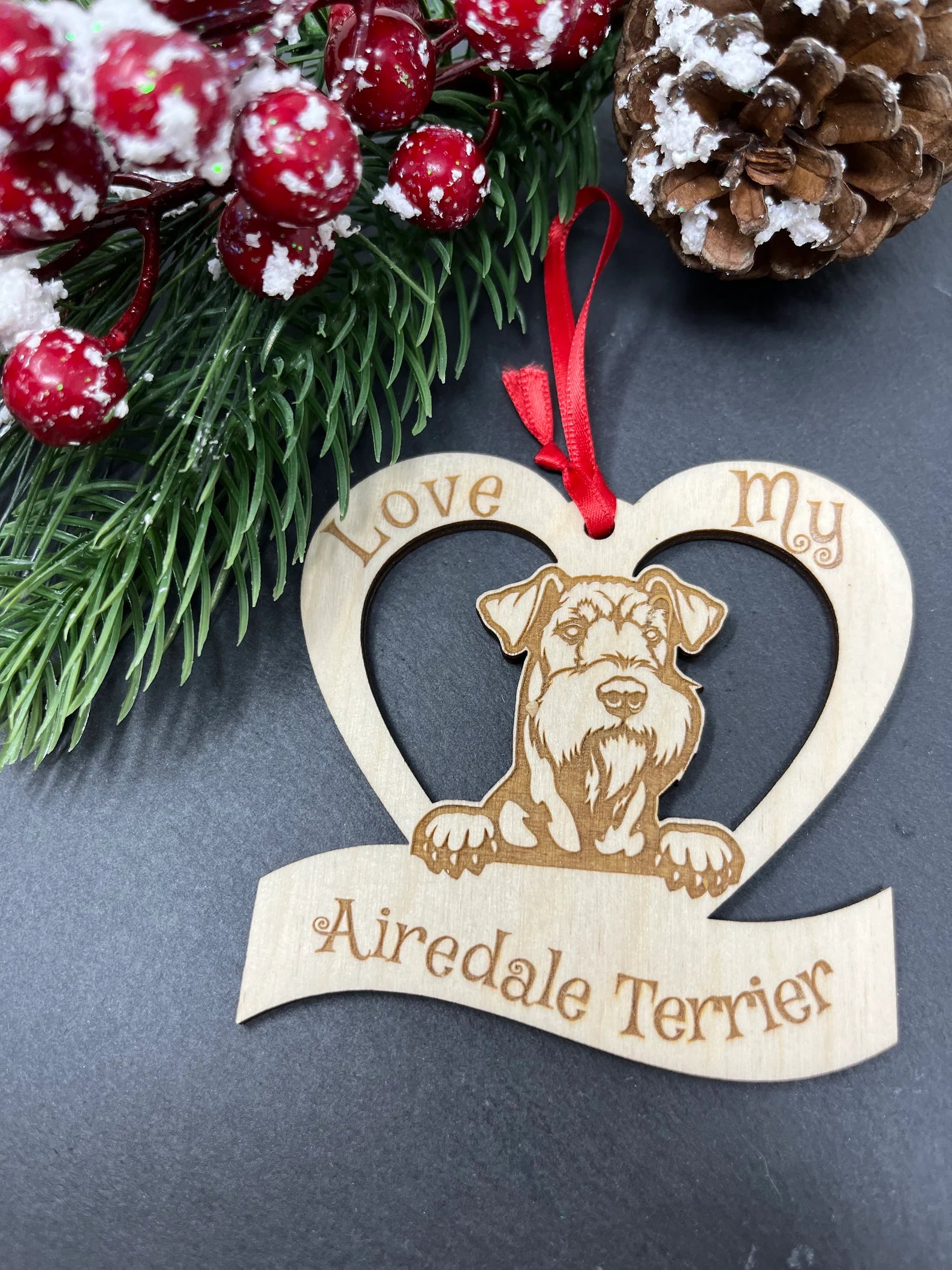 Laser engraved wooden ornament featuring an Airedale Terrier design, perfect for Christmas decoration.