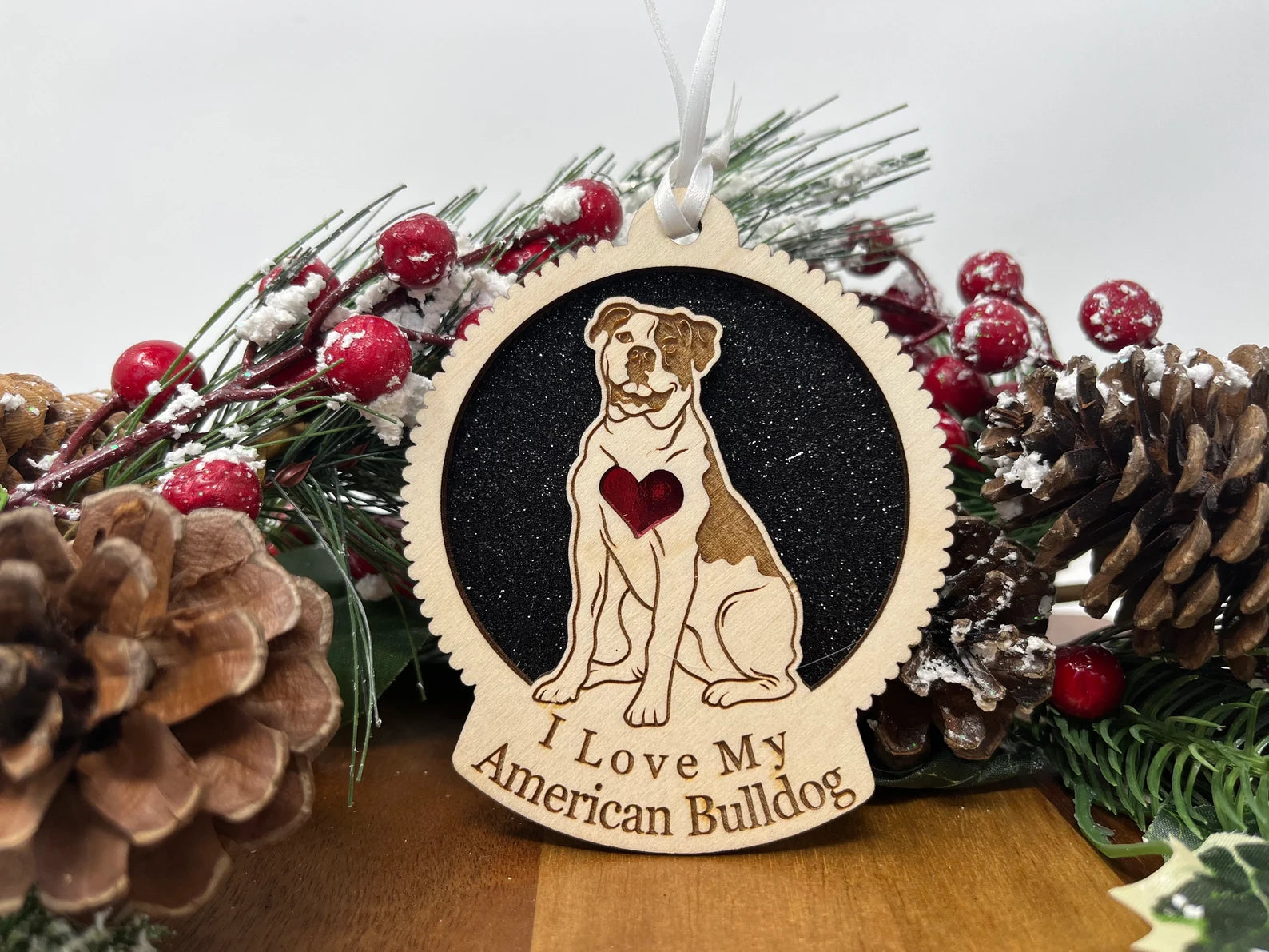 A beautifully crafted laser-cut wooden ornament featuring an American Bulldog silhouette, perfect for Christmas decoration.